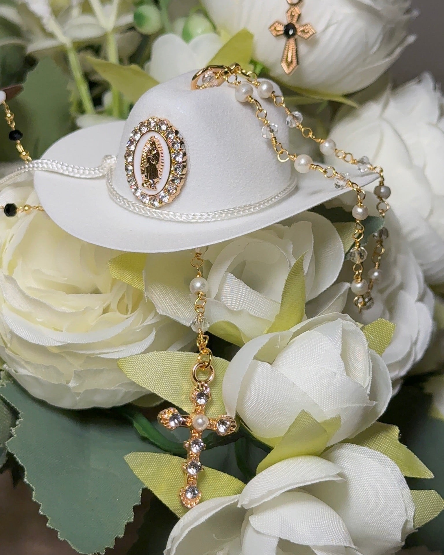Decorative hat with jewelry on a bouquet of white flowers