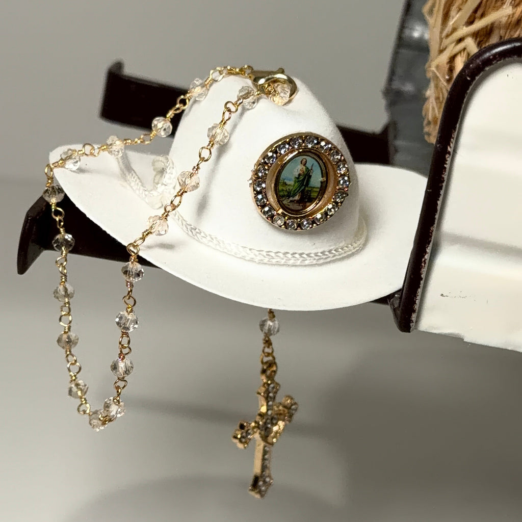 White cowboy hat with decorative elements on a gray background