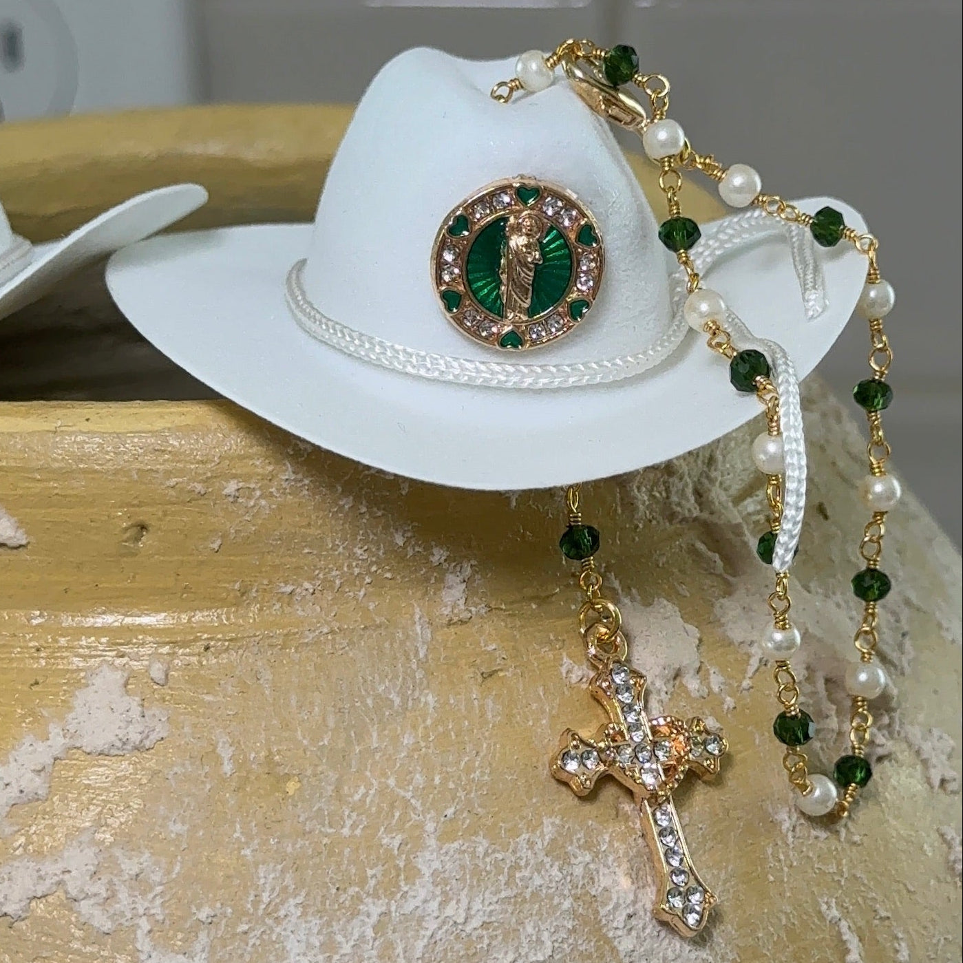 White cowboy hat with decorative elements on a textured surface