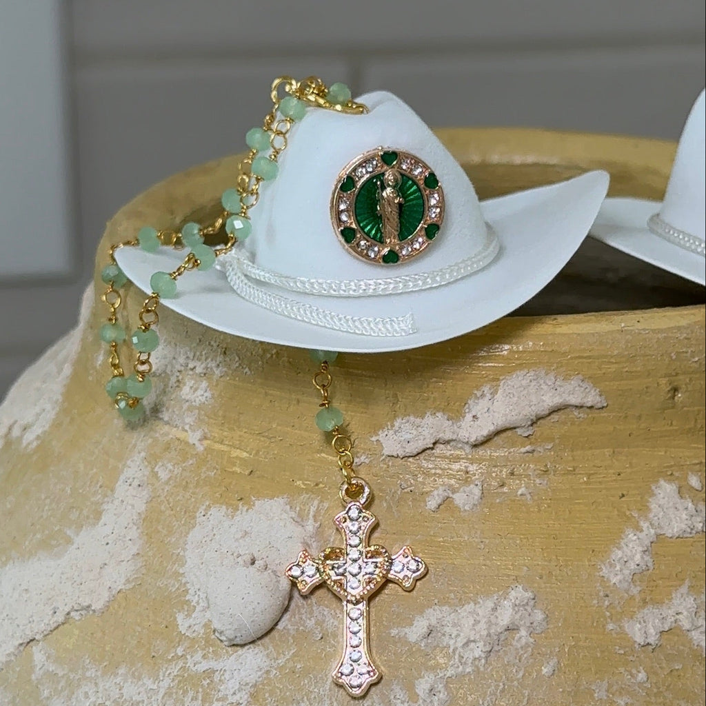 White cowboy hat with decorative elements on a textured surface